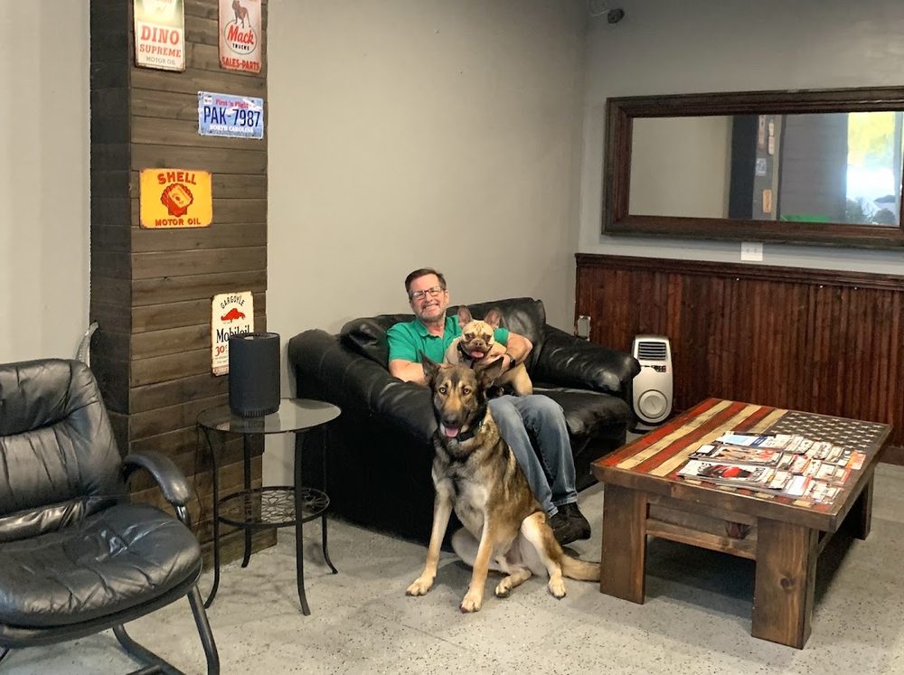 Waiting lounge with leather sofa and the shop dog